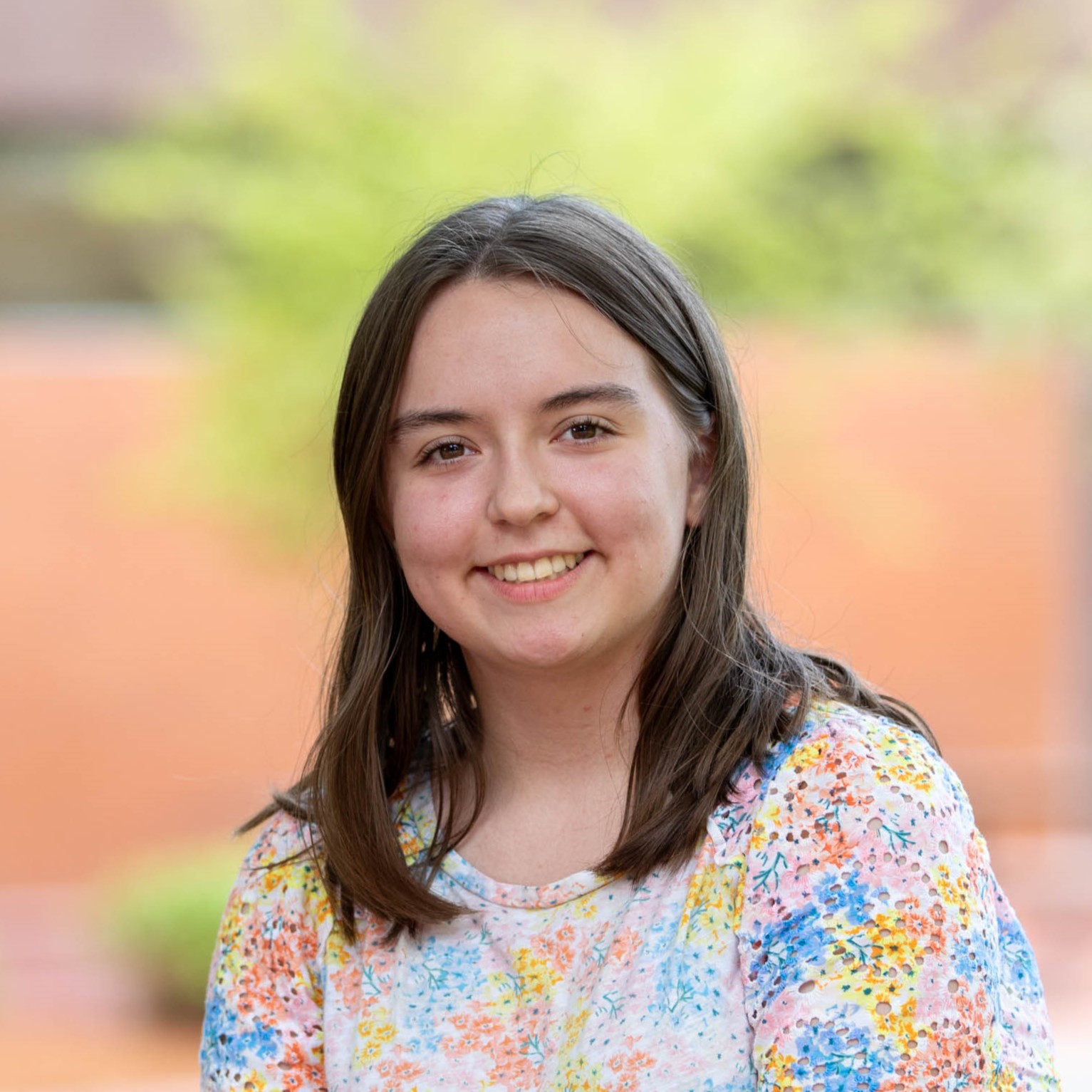 A profile photo of Kathryn Butler. She has mid-length brown hair and a bright smile.